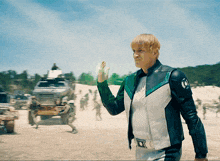 a man in a white and green jacket with the letter o on the sleeve