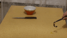 a bowl and a knife on a table