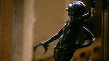 a close up of a statue of a person with a claw