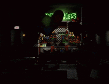 a dark room with a green sign that says ' tables ' on it