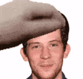 a pixelated image of a man 's face with a cat 's face on his head