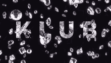 the letters k and u are surrounded by diamonds on a black background