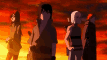 a group of people standing next to each other in front of a red sky .