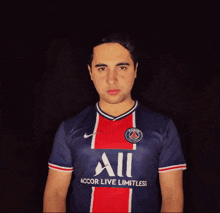 a man wearing a blue and red shirt that says accor live limitless