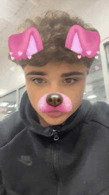 a young man wearing a black nike hoodie