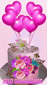 a birthday cake with pink balloons and flowers and the words feliz cumpleanos