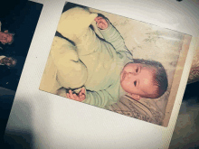 a picture of a baby laying on a blanket