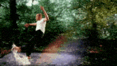 a man in a white shirt is jumping in a puddle of water