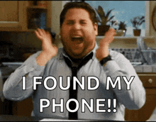 a man in a kitchen with his hands in the air and the words " i found my phone "