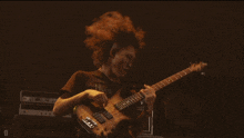 a man playing a bass guitar with a yamaha amplifier behind him