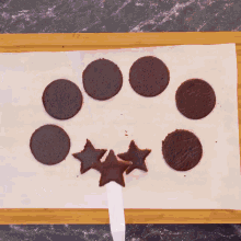 a box of chocolate cookies with circles and stars
