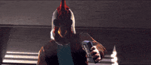 a man in a red jacket and blue jeans is running in a dark room