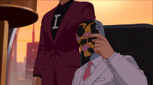 a man in a suit has the letter i on his sleeve