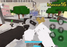 a person is playing a video game on a cell phone with the number 16 on the bottom of the screen .