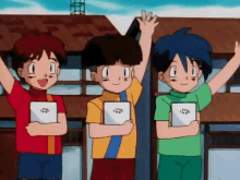 three boys are standing next to each other with their hands in the air