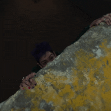 a person with purple hair and a green sweatshirt that says ' seoul '