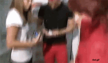 a blurry picture of a man and two women with rbd.gif written on the bottom right