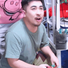 a man in a green shirt is playing a game