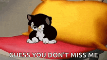 a cartoon cat is sitting on a bed with the words `` guess you don 't miss me '' written below it .
