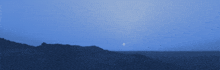 a blue sky with a few clouds and the moon