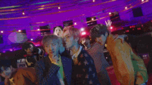 a group of people are dancing in a room with a sign that says party n 2021