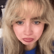 a close up of a woman 's face with blonde hair