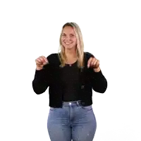 a woman wearing a black cardigan and blue jeans is dancing