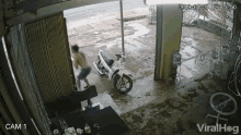 a motorcycle is parked outside of a building with a camera recording it