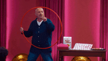 a man holding a hula hoop in front of a box of sugar flakes cereal