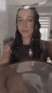 a woman is taking a picture of herself through a glass