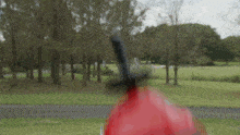 a blurry picture of a person holding a red object