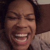 a close up of a woman making a face with her mouth open
