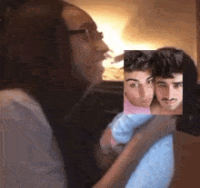 a woman is sitting in a car with two men .