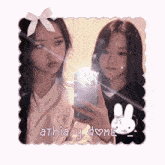two girls are taking a picture of themselves with the name athia y dome written on the bottom