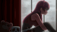 a girl with red hair sits next to a teddy bear