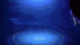 a person is swimming in a dark pool with a blue light behind them
