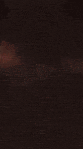a blurred image of an explosion with sparks flying in the dark