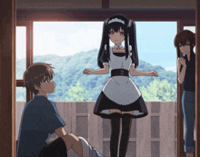 a girl in a maid outfit is standing next to a boy and another girl