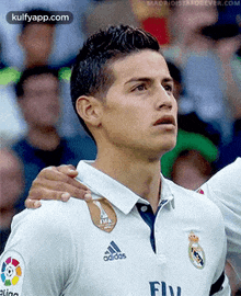 a close up of a soccer player wearing a adidas shirt