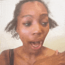 a woman with curly hair making a surprised face