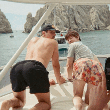 a man and a woman are on a boat in the water