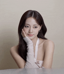 a woman wearing white gloves and a white dress