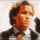 a close up of a man 's face with a red background
