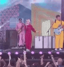 a group of people are playing instruments on a stage .
