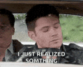 a man is sitting in the back seat of a car with his eyes closed and says `` i just realized something '' .