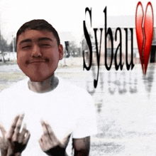 a man in a white shirt is giving the middle finger in front of sybau