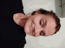 a close up of a woman 's face with her eyes closed and a smile on her face