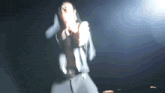 a blurry picture of a man in a suit holding a gun
