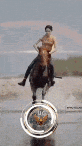 a woman is riding a horse in front of a logo that says university of california