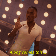 a man in a white shirt says " along comes this " in yellow letters